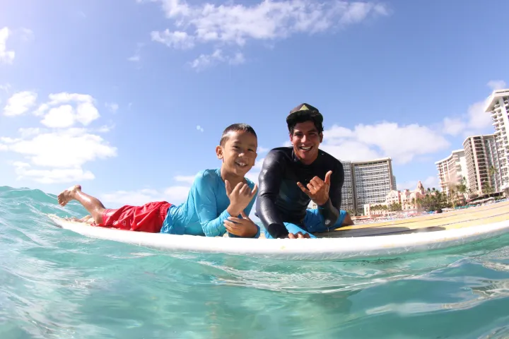 boy getting surf lesson honolulu