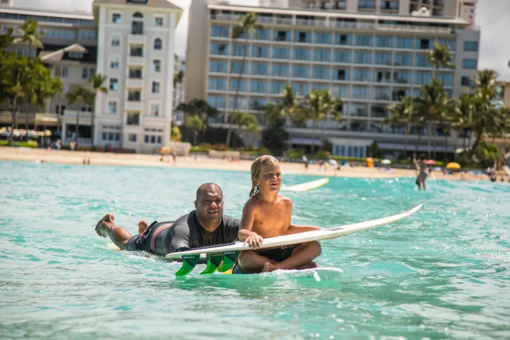 boy getting surf lesson honolulu