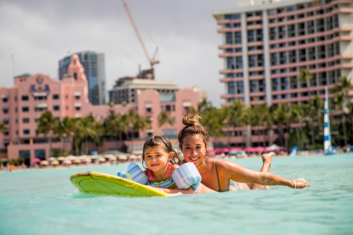 little girl taking surf lesson